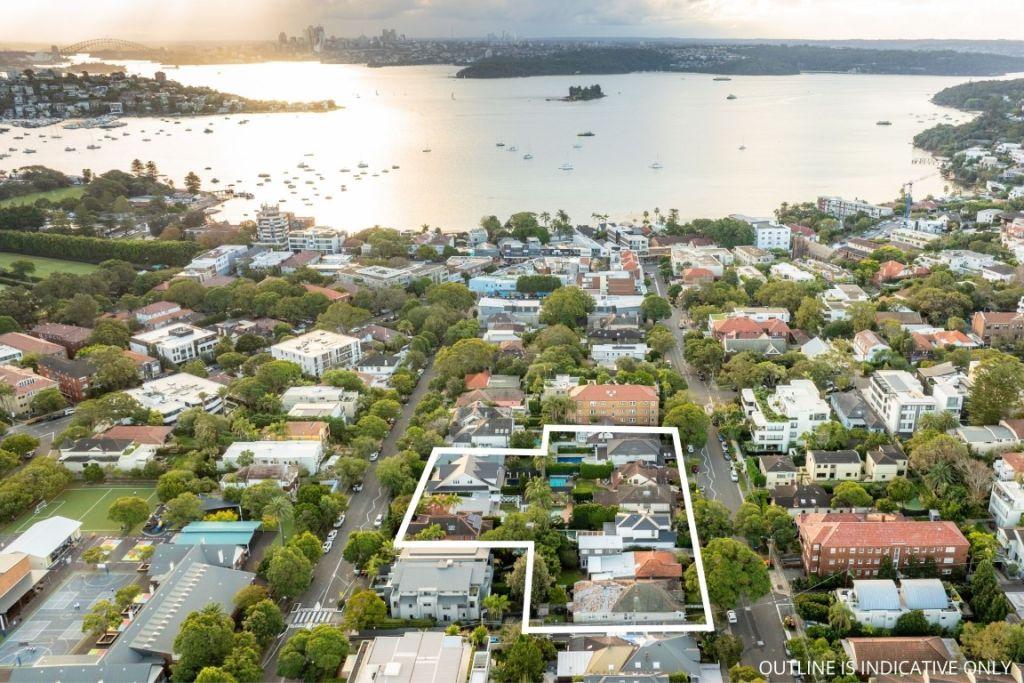aerial of 12 houses with rose bay in background