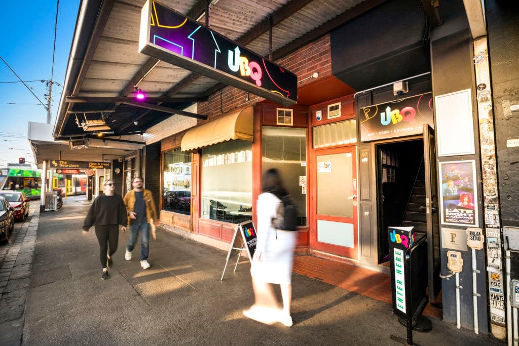 UBQ signage lights up the footpath with an entry leading guests upstairs.