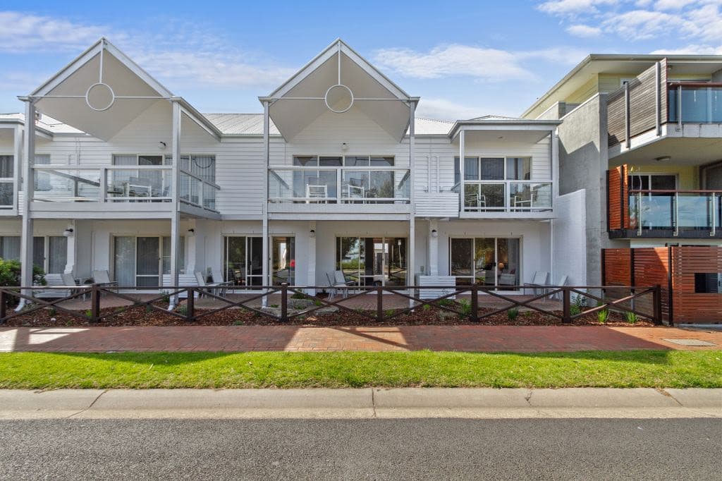 The white motels are pictured from the front with peaked roofs.