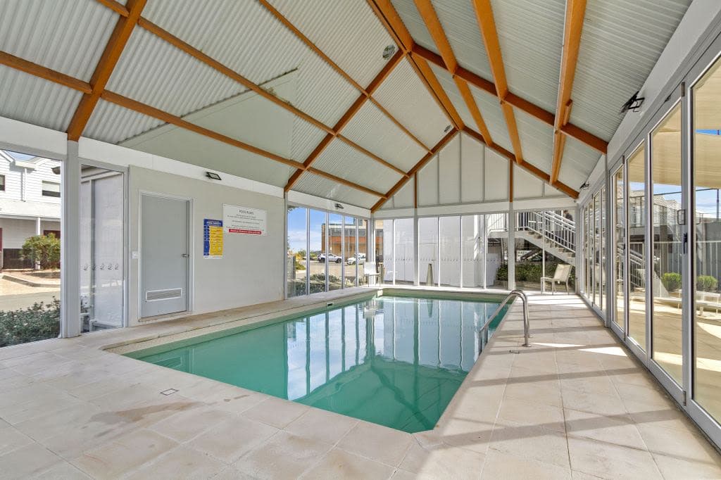 The indoor pool is in-ground with a roof over the top.
