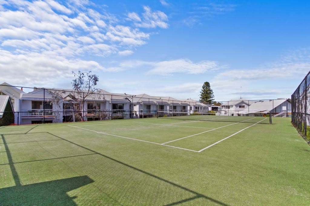 A grass-green tennis court.