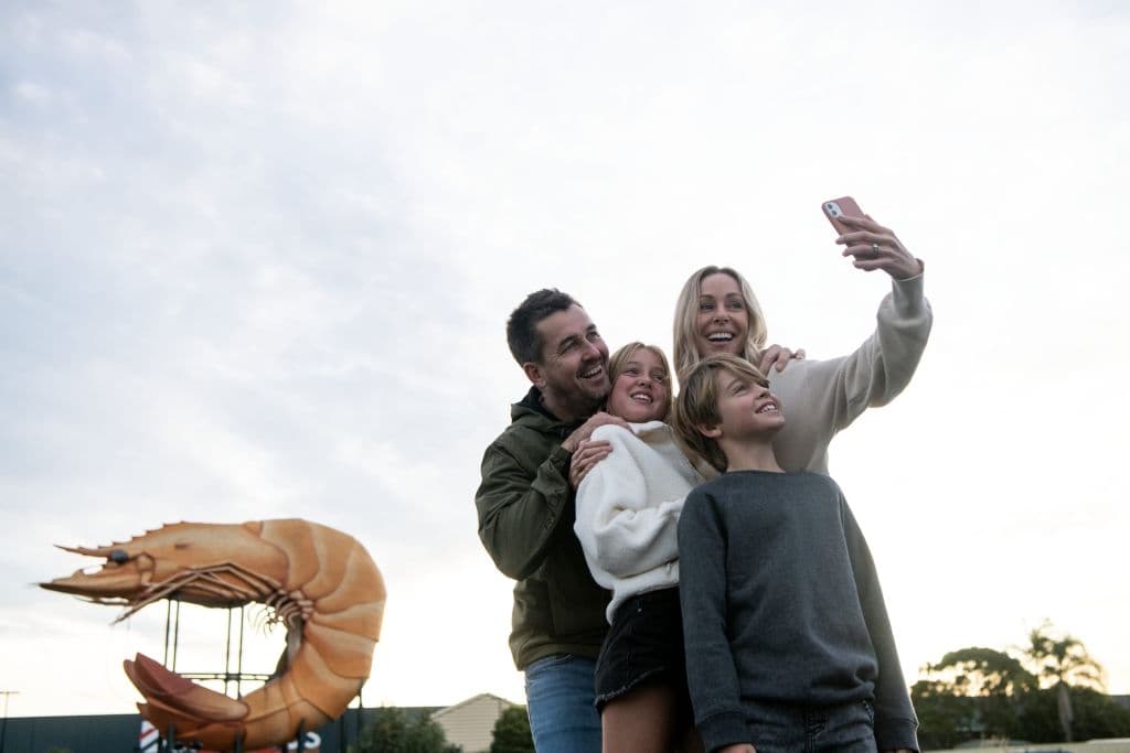 Family taking a photo at the Big Prawn, Ballina
