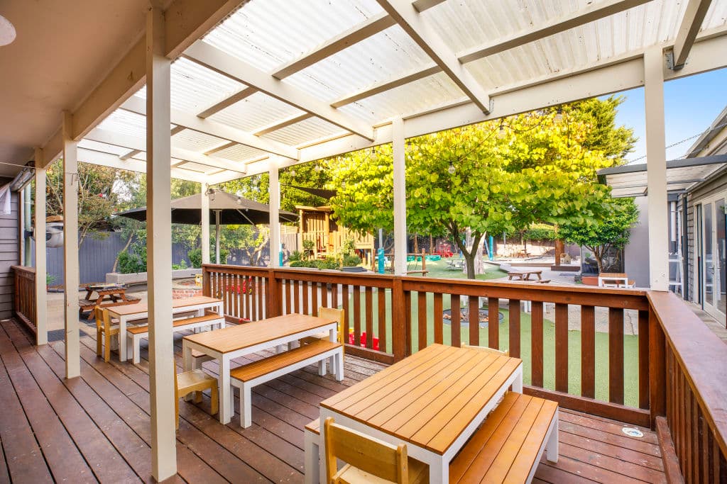 Rows of undercover tables and chairs are set up outside.