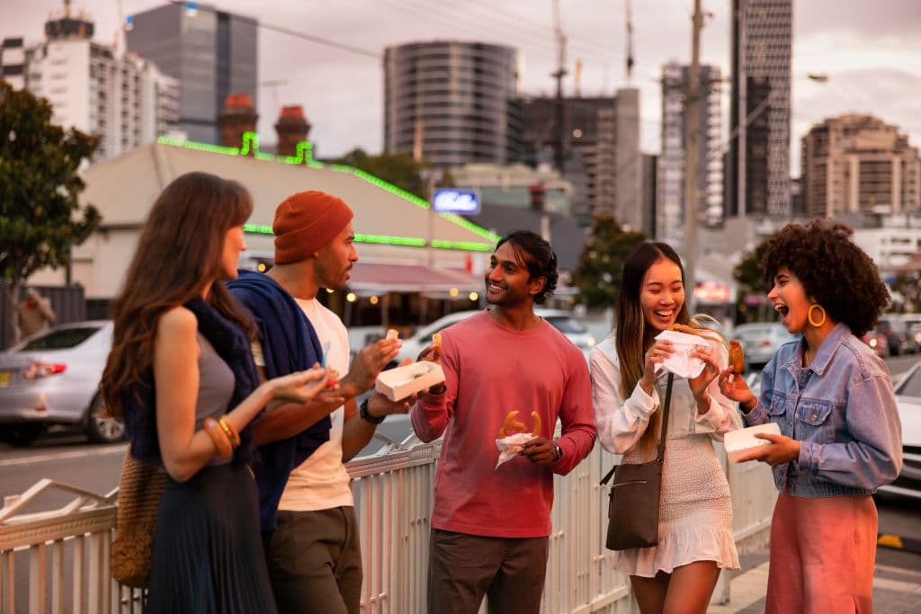 Friends walking through Little India in Harris Park.