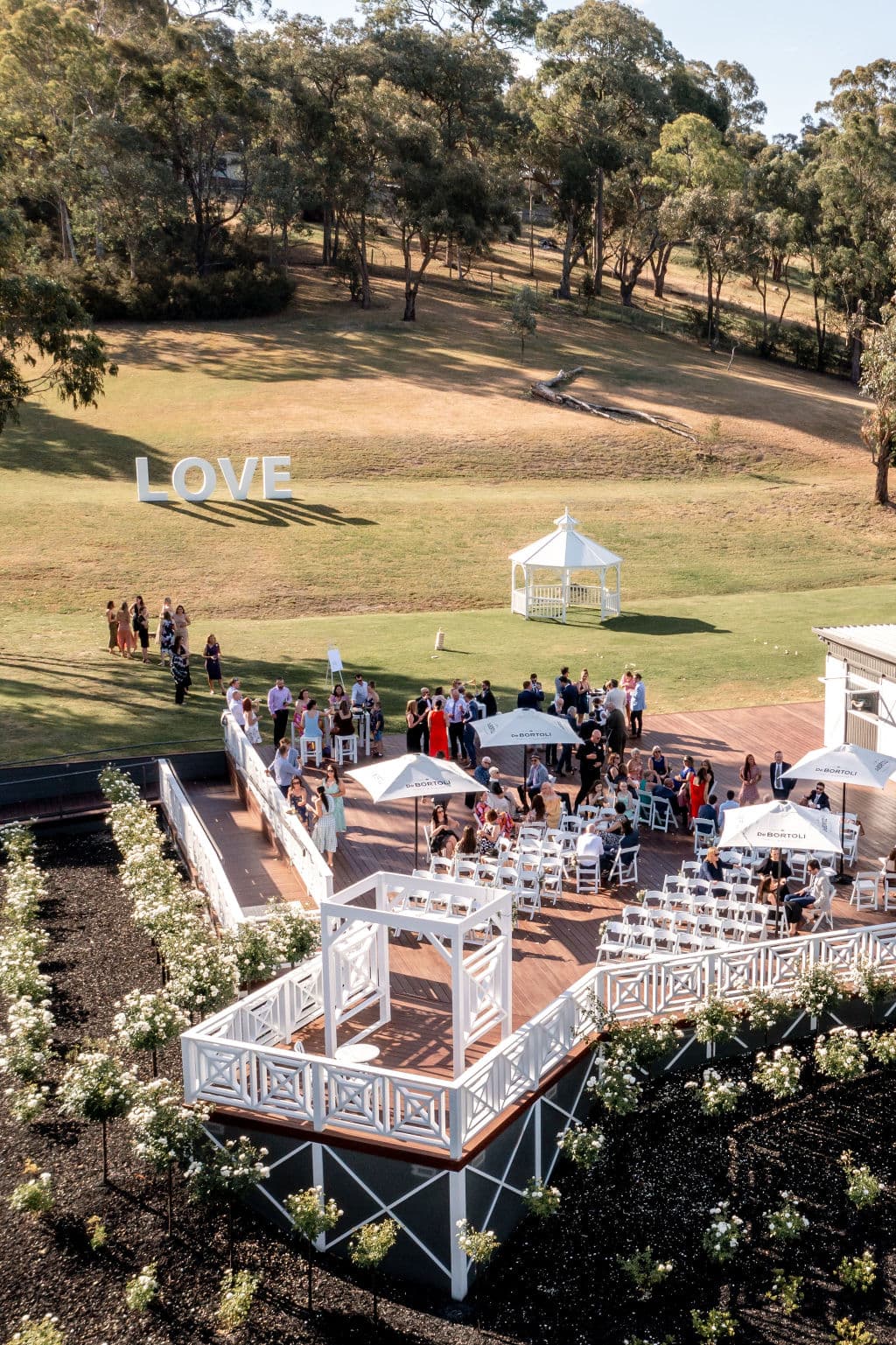 Loved ones celebrate a wedding on the sun-lit deck at Bramleigh Estate.