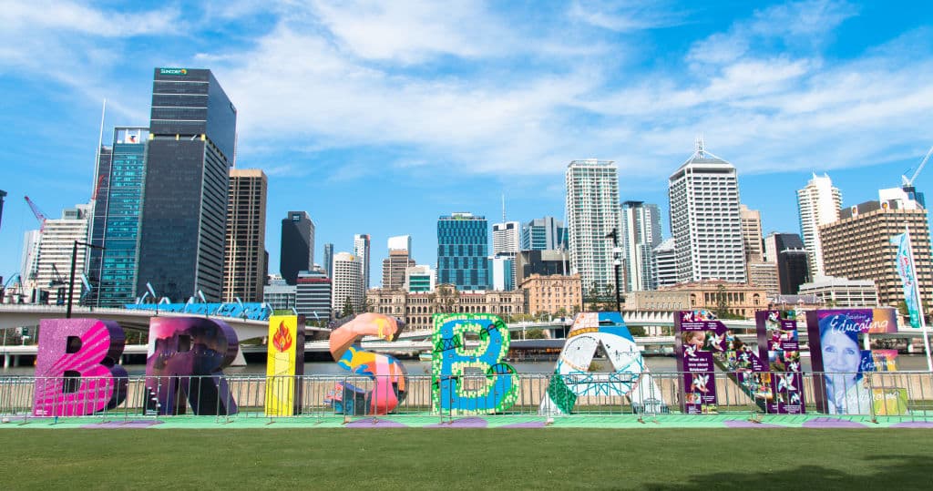 View of Brisbane City skyscrapers with colorful block characters of city name, taken from the Southbank