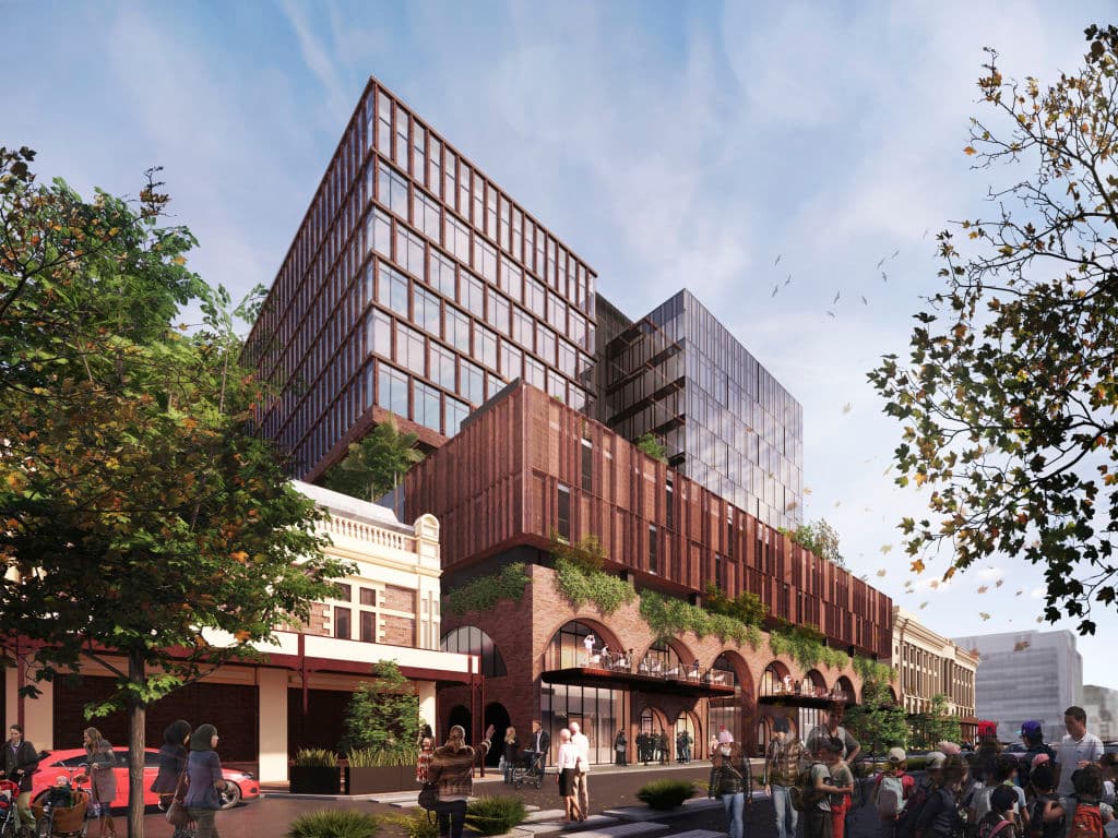 To_break_down_the_mass_the_new_office_building_is_broken_into_two_components_above_the_Corten_screened_carpark._Render_Woods_Bagot_fscwx8