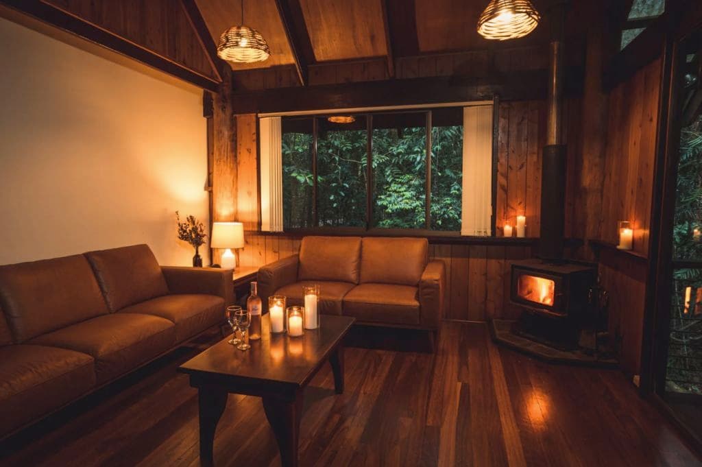 Inside a living area with a fireplace blazing and warm lighting on.