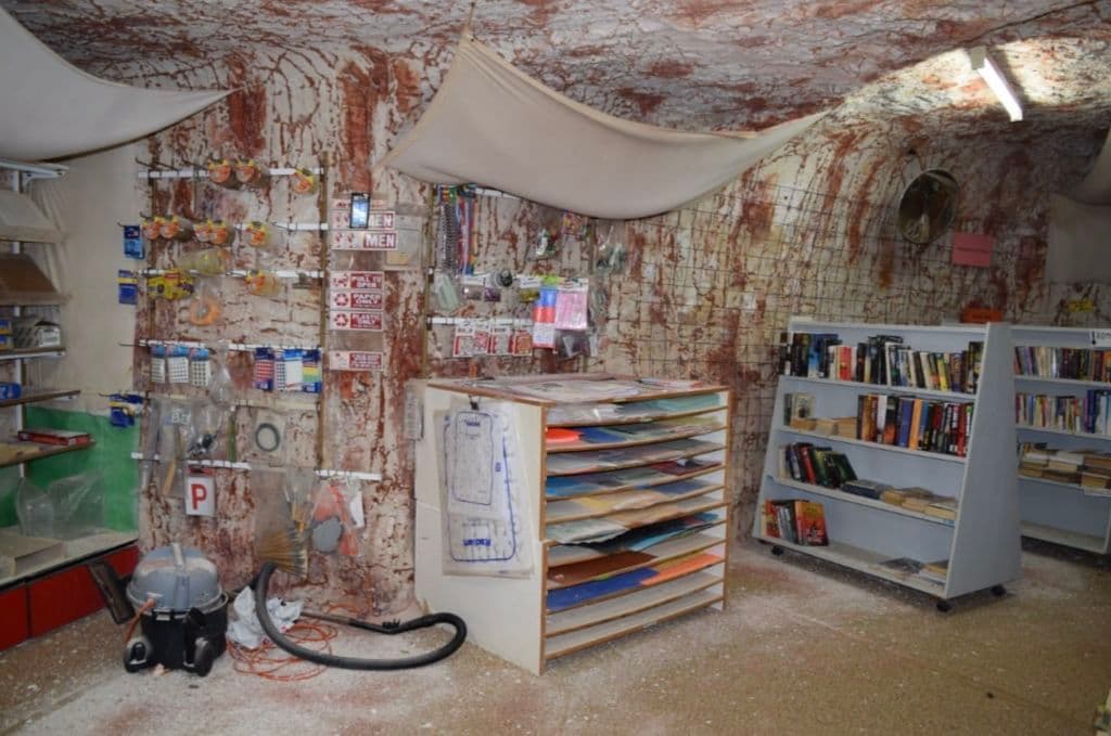 Underground bookshop with shelving.