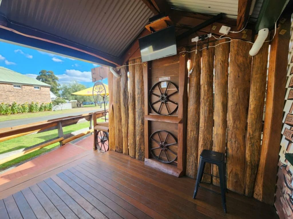 A warm inviting deck with country farming wheels on display outside the main venue.
