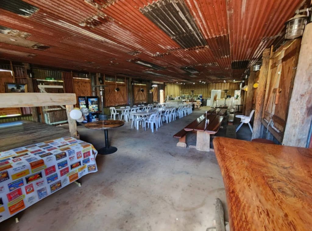 An covered space large enough for big groups fitted out with tables and chairs.