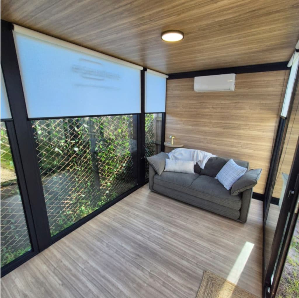 A room with glass windows and a wooden floor.