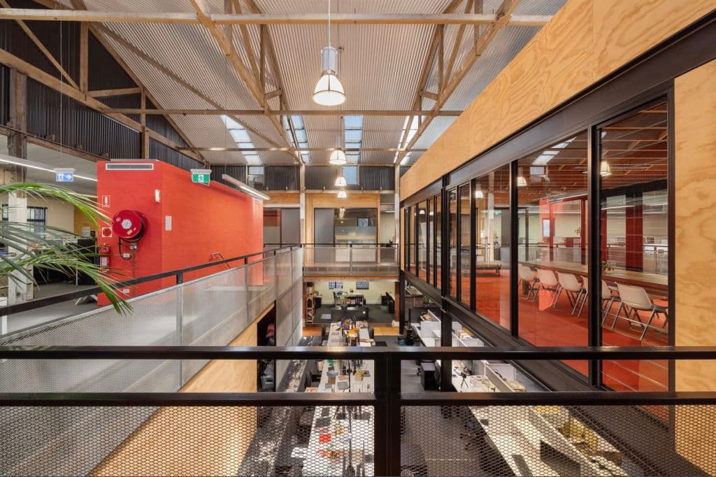 The space shows exposed beams, high ceilings and contemporary office fixtures and fittings.