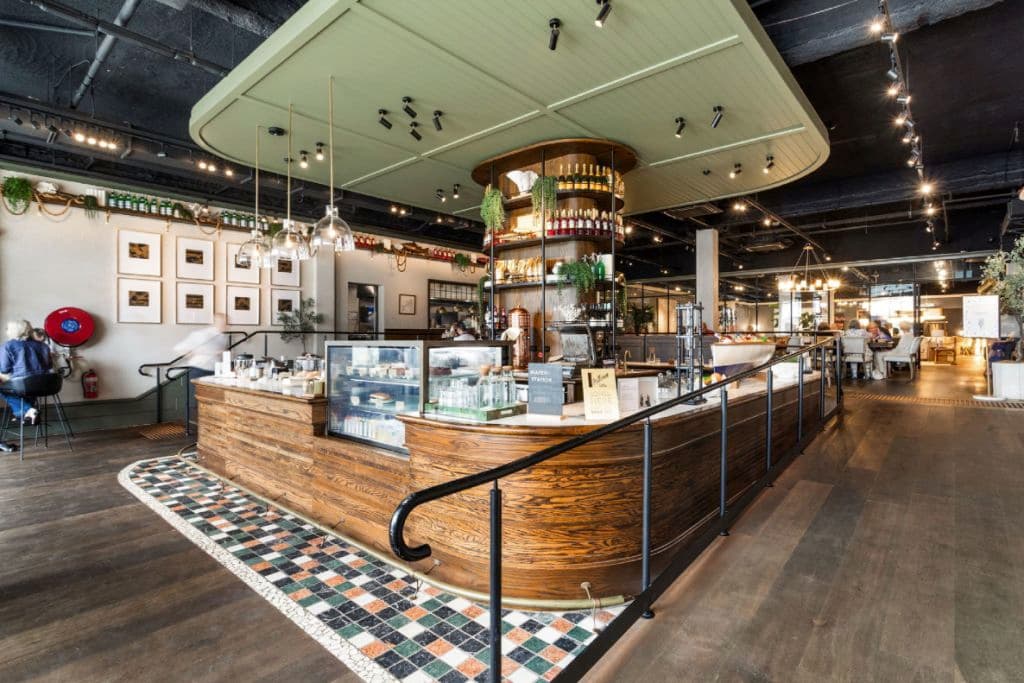 A modern looking cafe space with wood, tiles and decorative interiors.