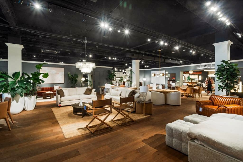 inside a showroom with dark lighting and furniture throughout.