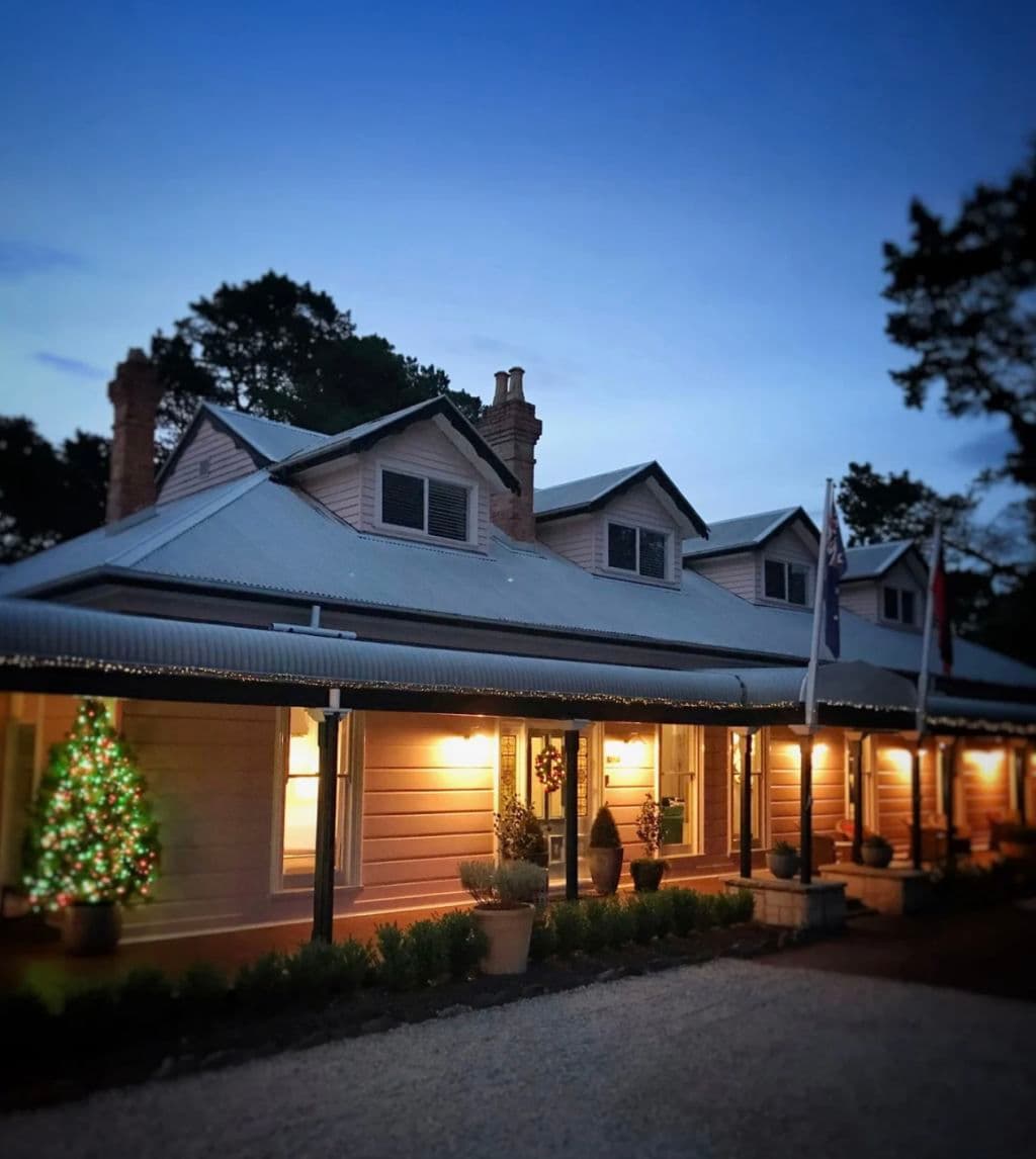 Evening darkness surrounds the front of the historic home.