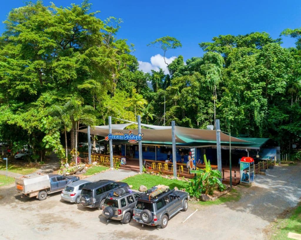 An aerial shot of the cafe under a canopy with cars out the front.