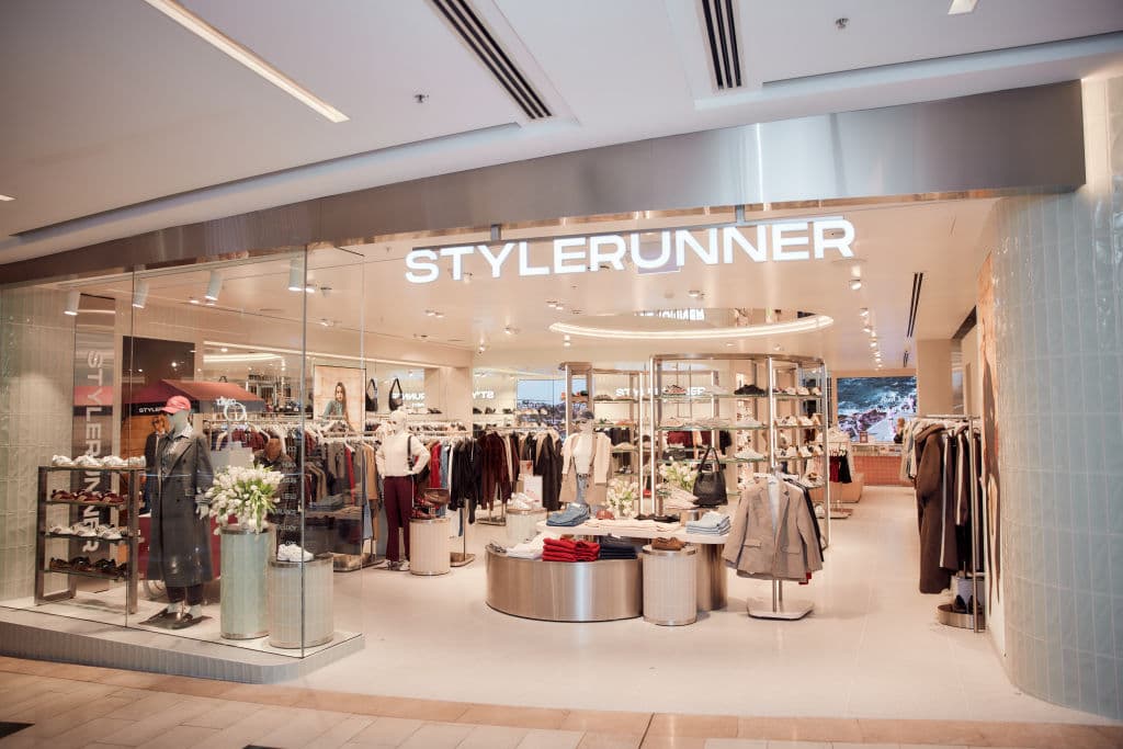 The front of a store with bold white lettering spelling STYLERUNNER in Westfield complex
