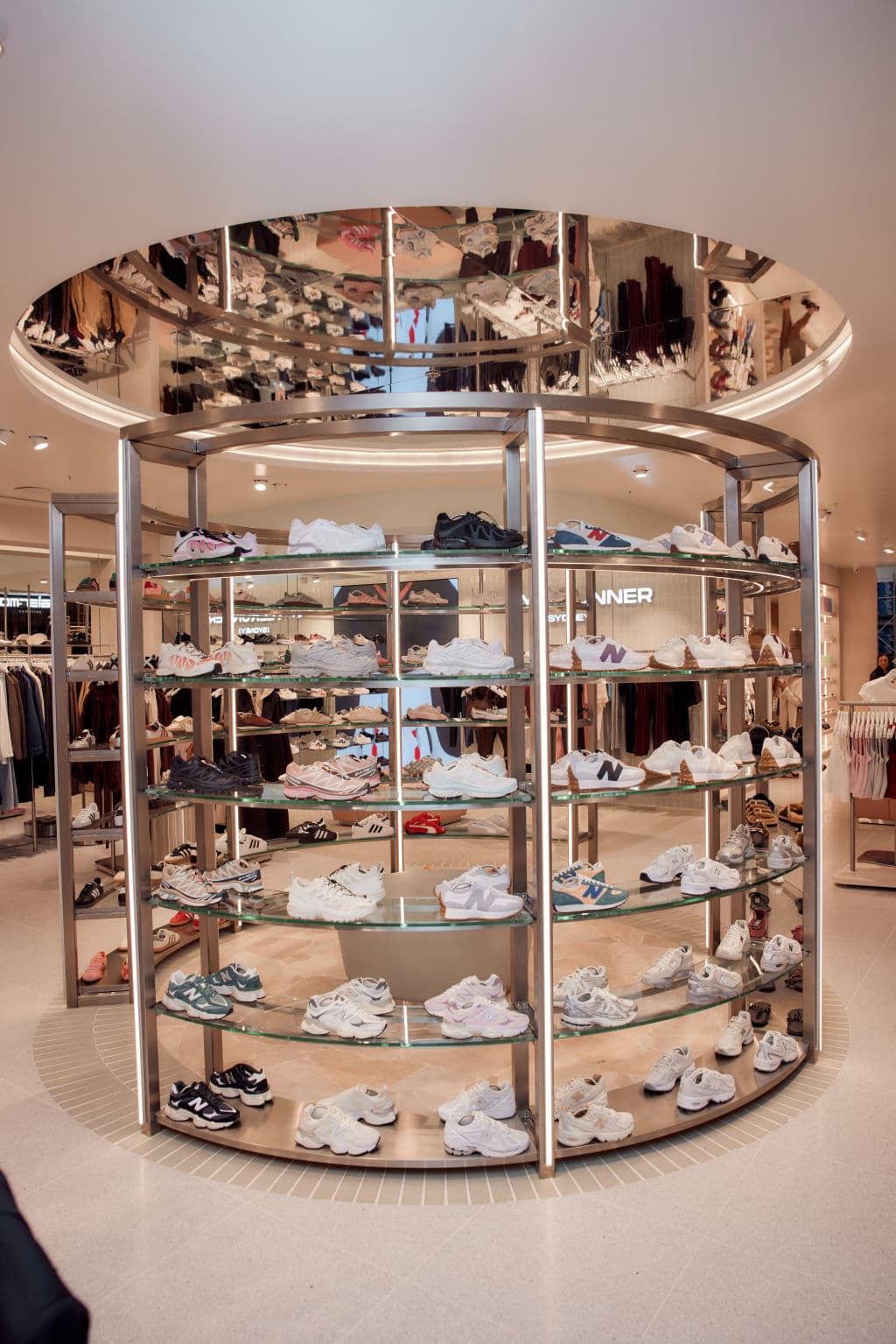 A circular shoe rack has six levels of shoes on display.