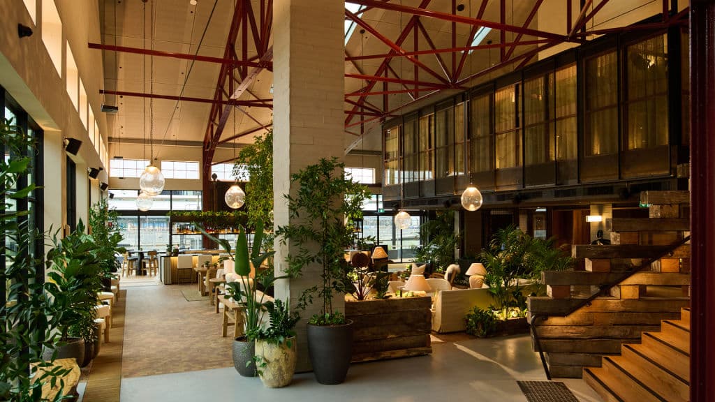 view from hotel lobby of Crane Bar under soaring roof that was once a goods shed