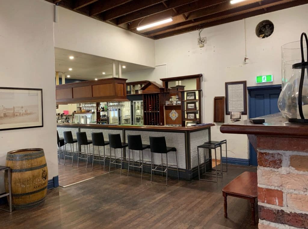 Inside a bar shows high-top seating.