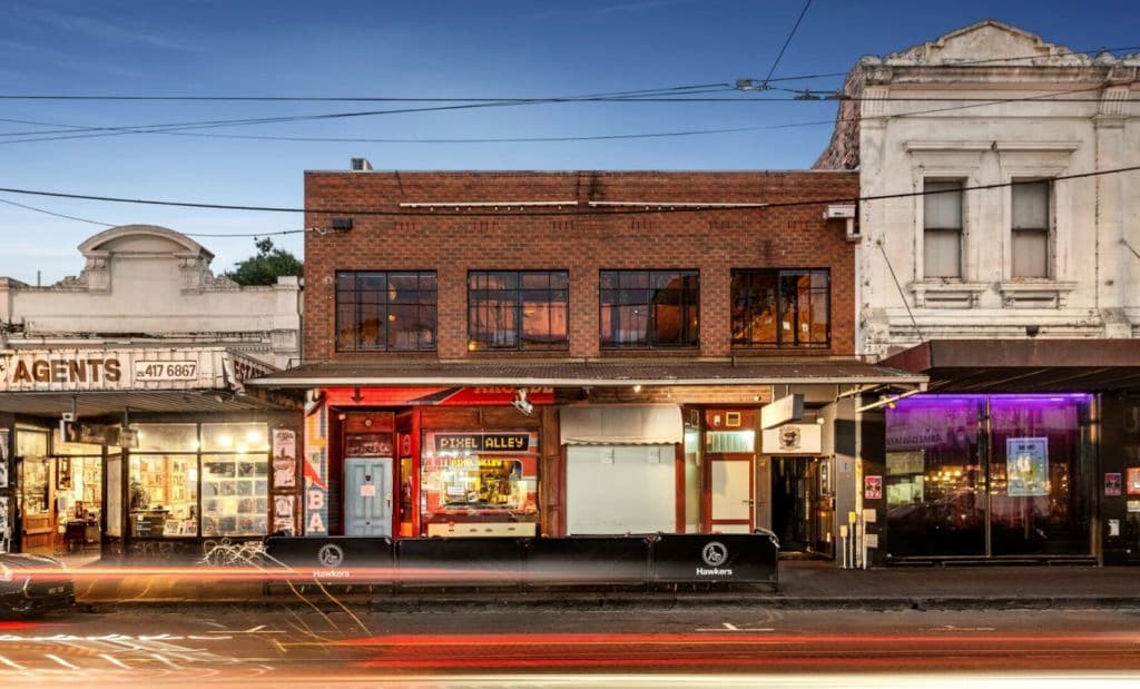 A night time shot of the red brick building.