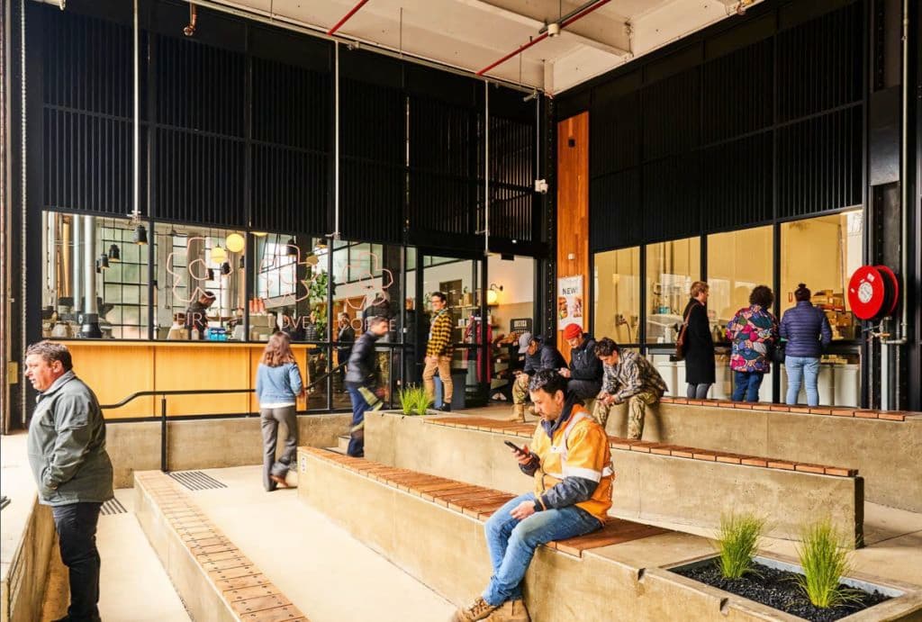 Workers sit on seating outside a cafe on the ground floor.