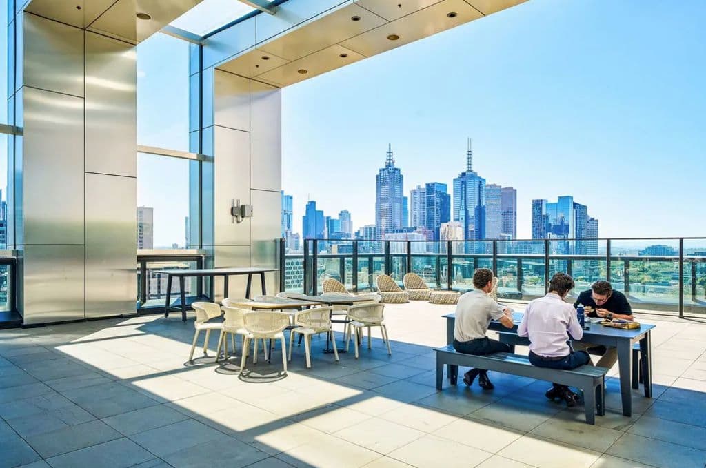 A light-filled level 21 terrace shows workers enjoying a bite to eat in the sun.