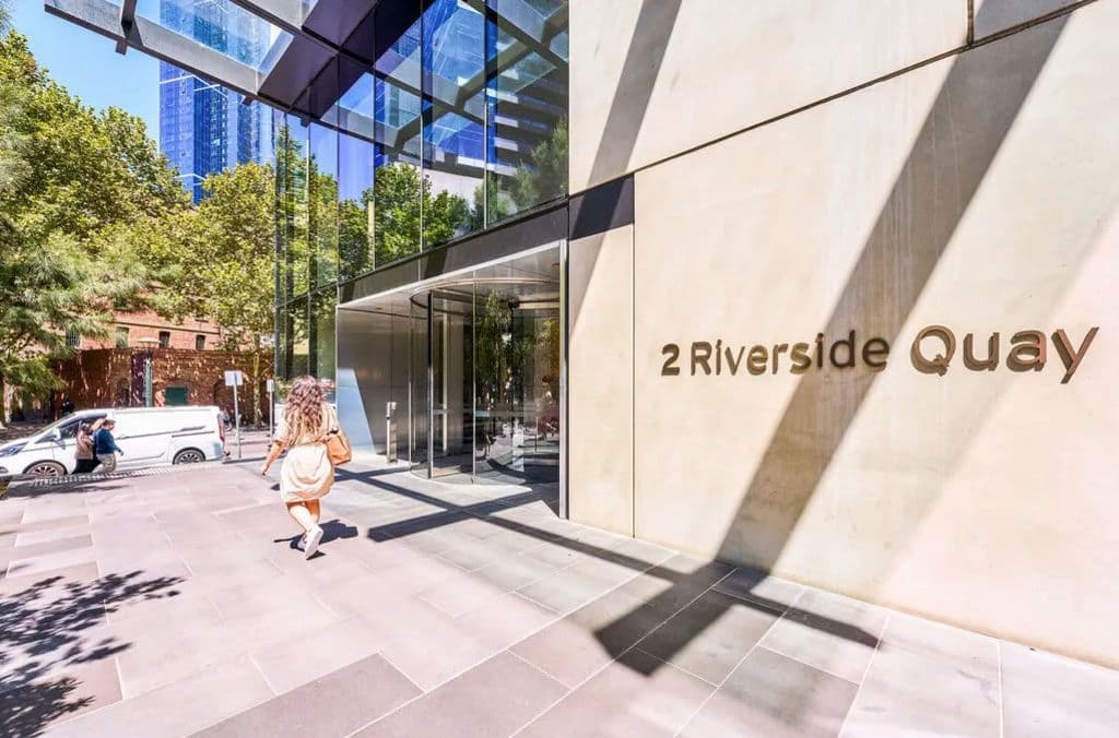 The outside of the building at ground level, with gold writing spelling out the address.