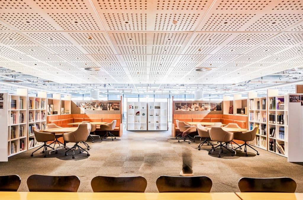 Chairs are dotted around a room/