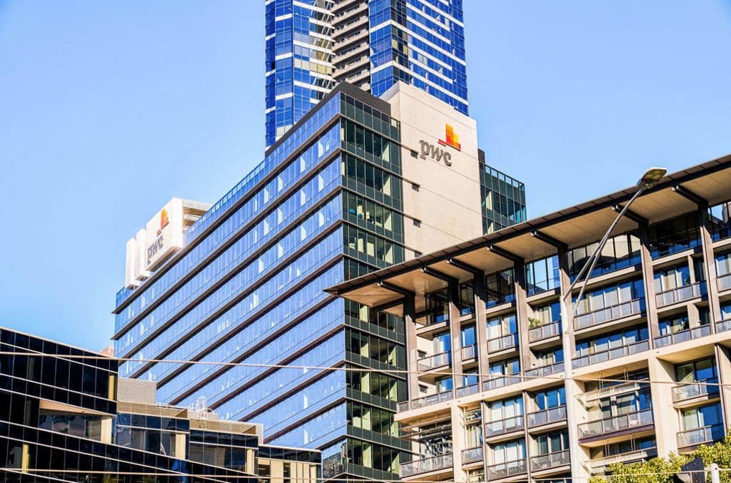 The building and its logo seen from outside at street level looking up.
