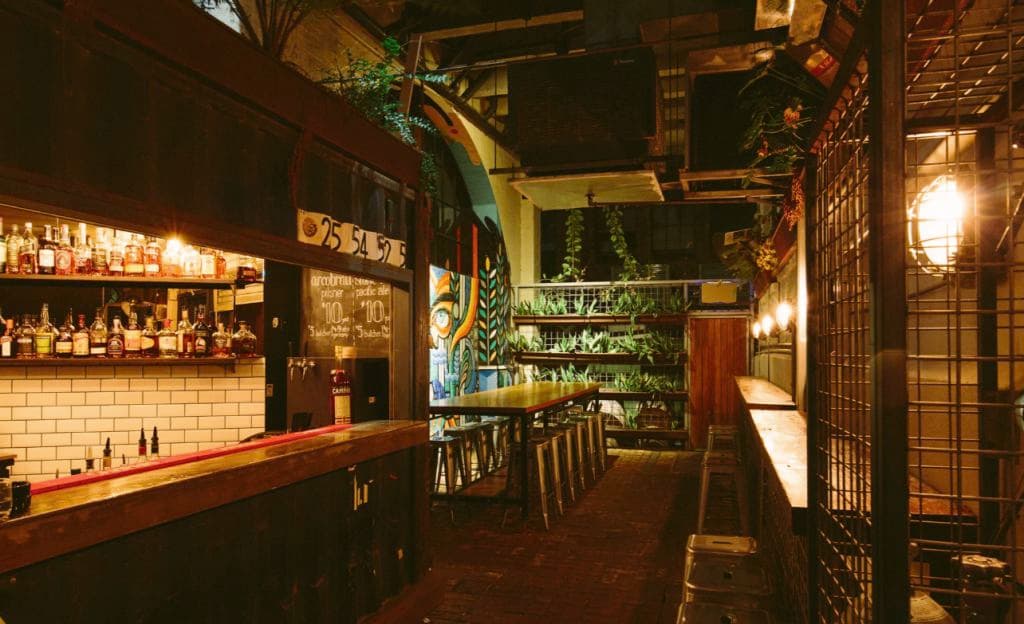 A space in the bar that offers diversity, with a mural lighting up the area.