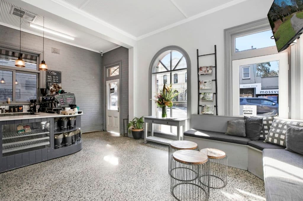 The front of the shop is painted with greys and whites and looks tranquil.