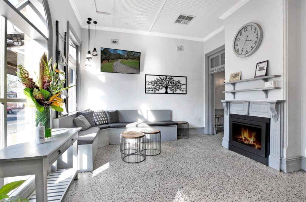 A gas heater replaces an old fireplace in the shopfront.