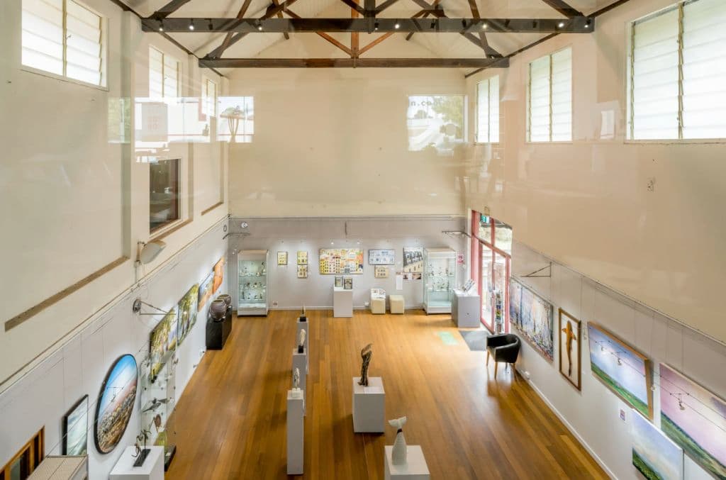 Light filters through windows from above the expansive gallery space.