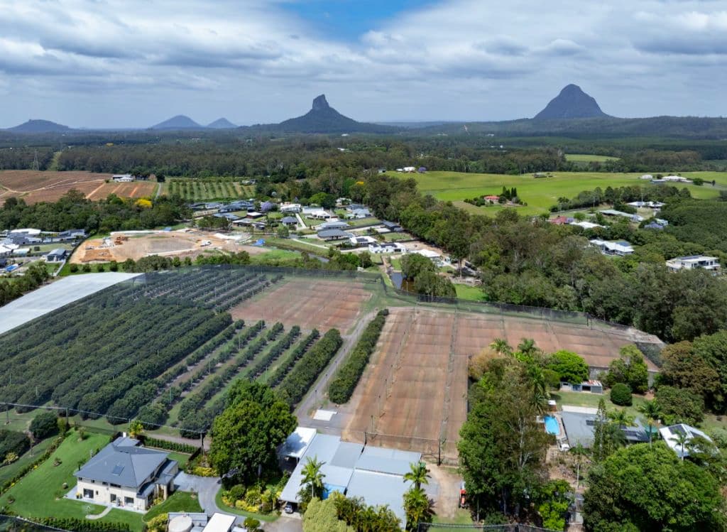 An aerial shot of the property shows lush green landscapes