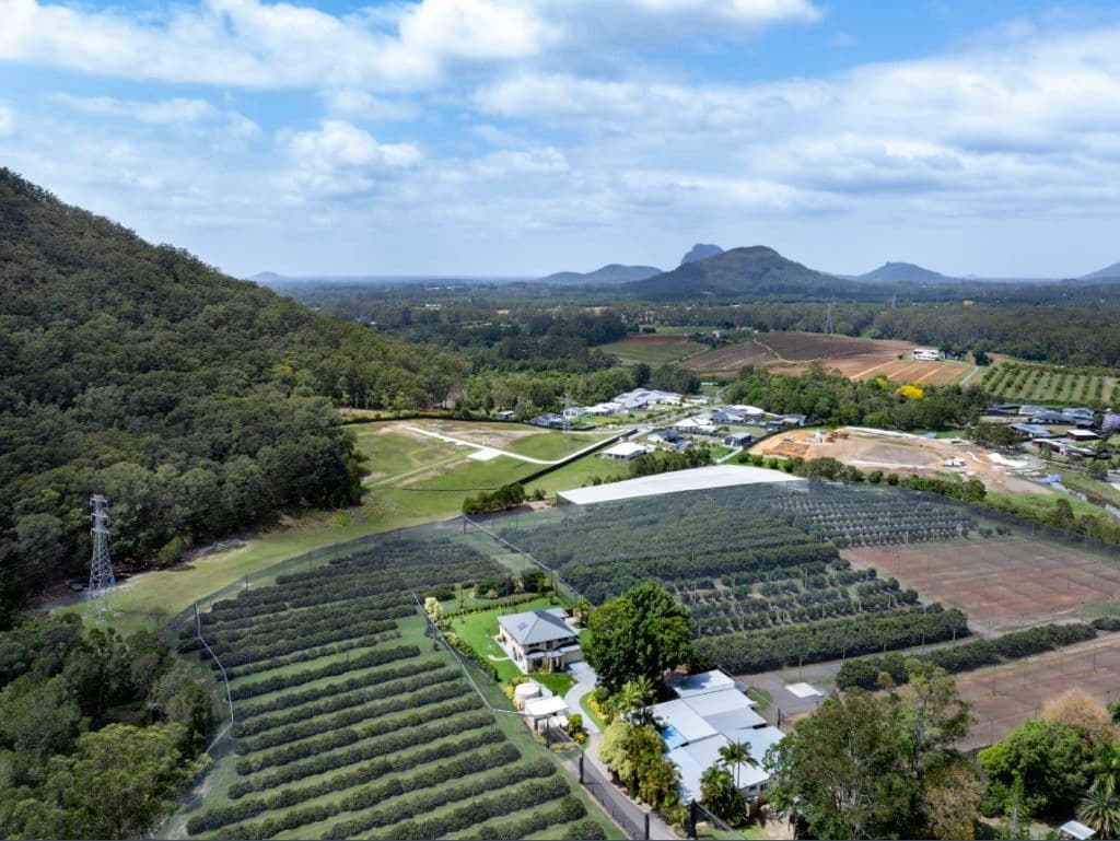 Aerial views of the farm and hinterland with mountain views.