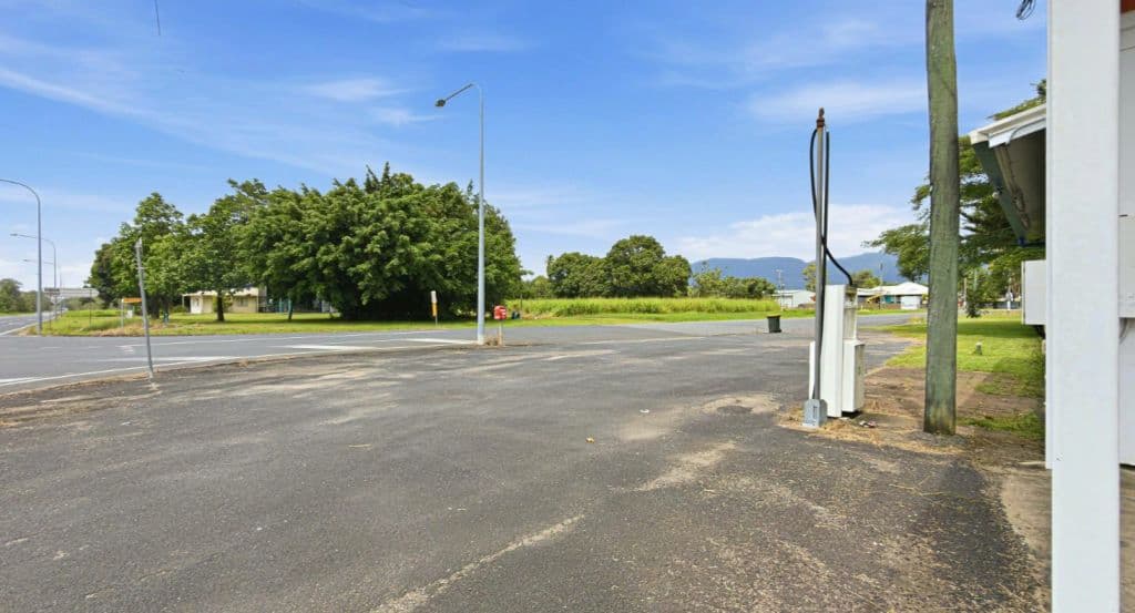 A petrol pump sits on concrete.