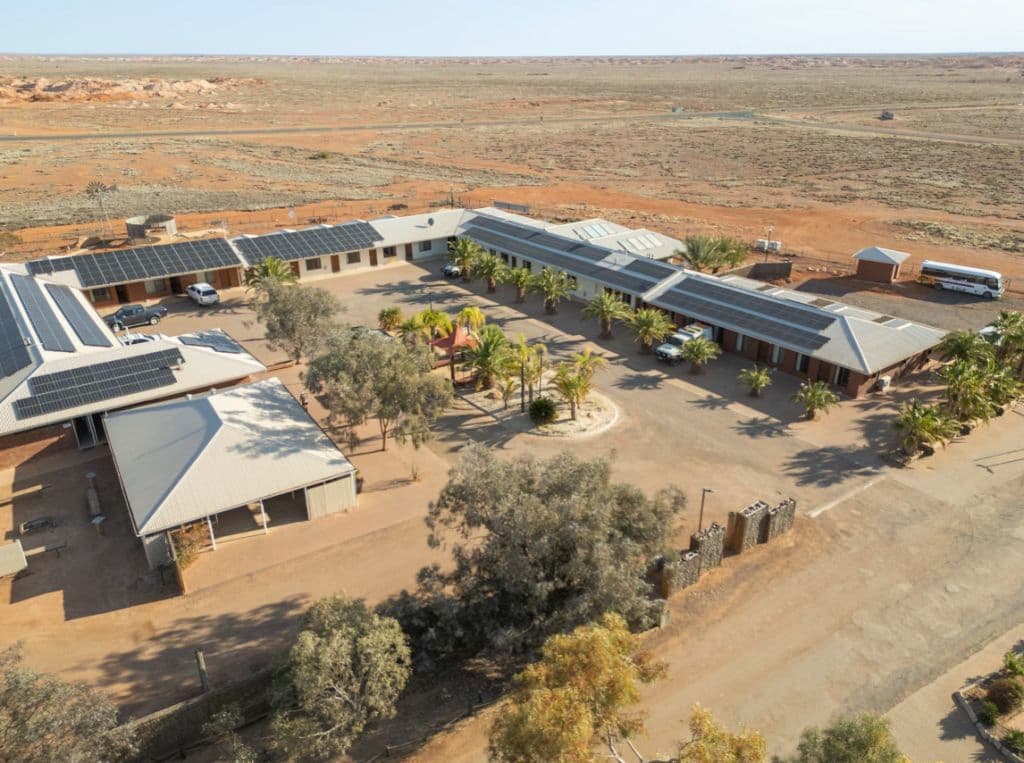 An aerial view of motel rooms around a central space.