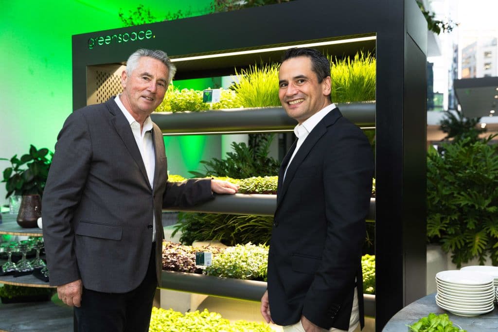 Greenspace CEO and founder Peter Fox with John Bristowe, general manager of Amora Hotel Brisbane, with a verdant microfarm.