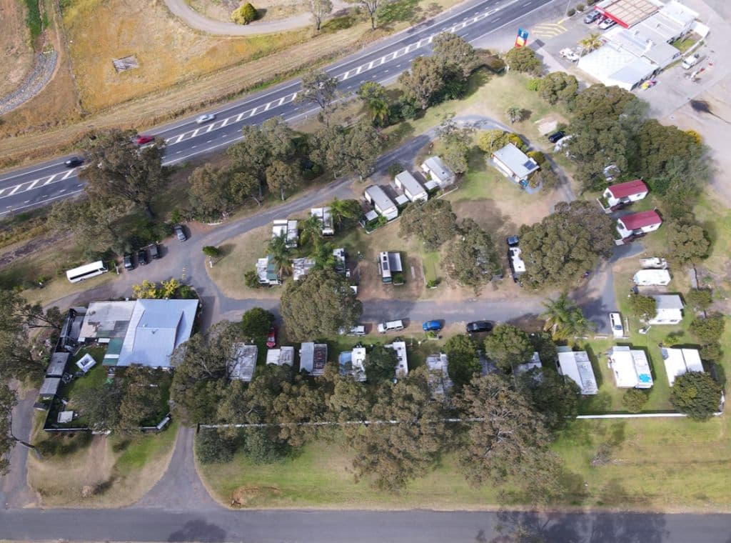 Aerial shot showing the caravan park spans 9,562 square metres along the New England Highway.