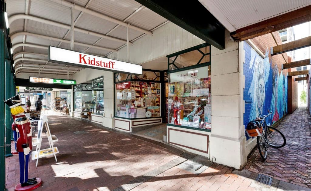 The signage hanging down from the footpath saying Kidstuff.