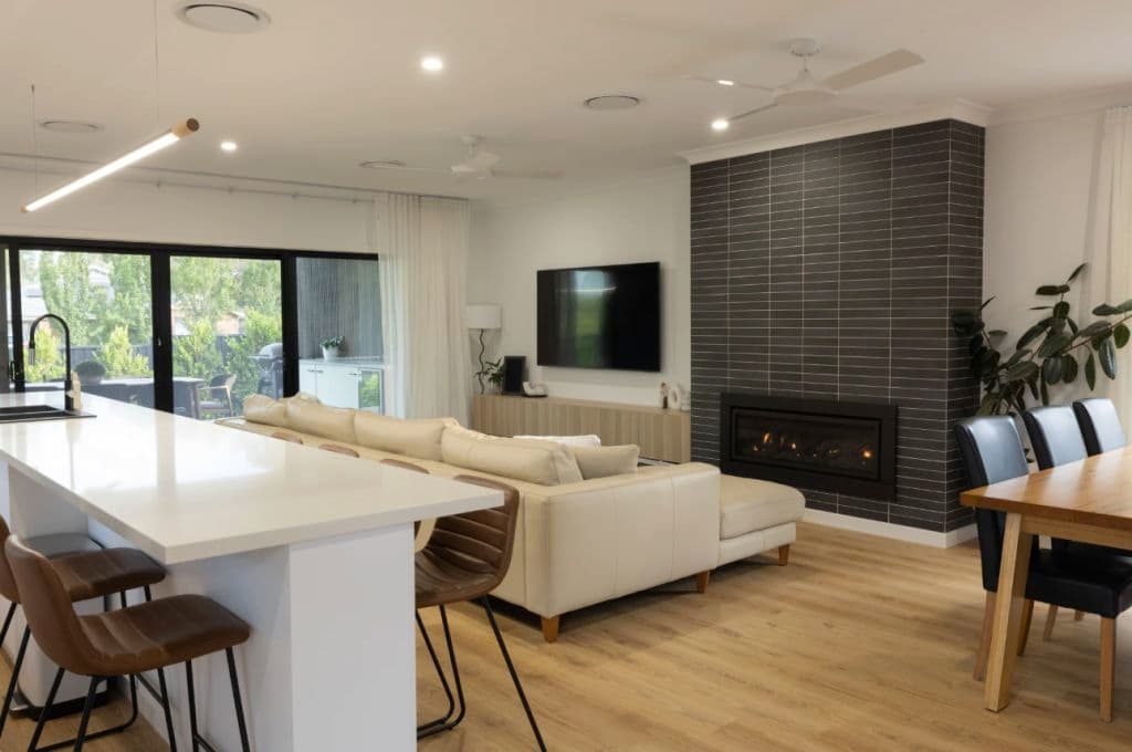 A lounge and kitchen with a fireplace.