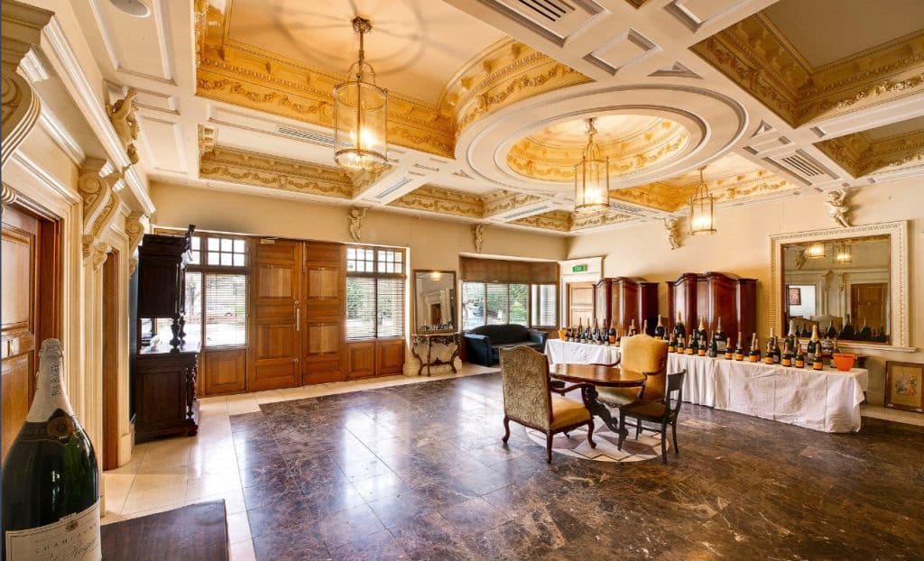 A room with nice marble floors and ornate ceiling decoration.