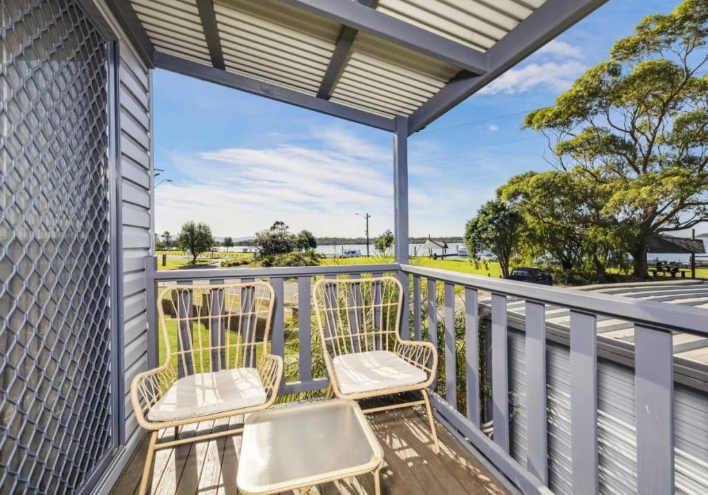 Modern outdoor furniture on the cabin balcony.