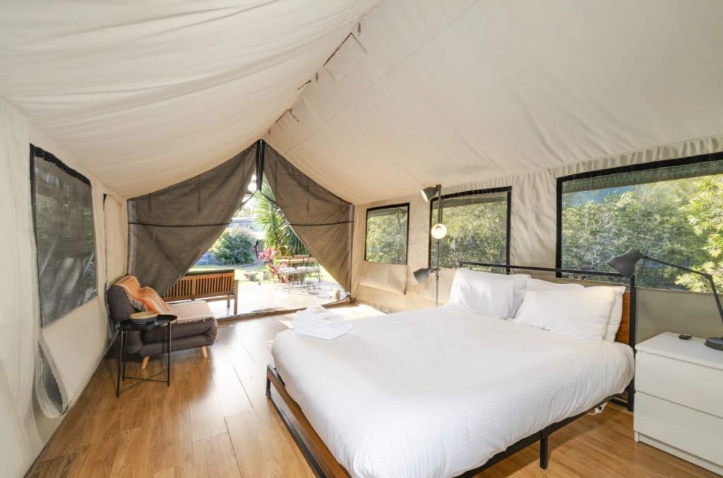 The glamping tents show a queen size bed.