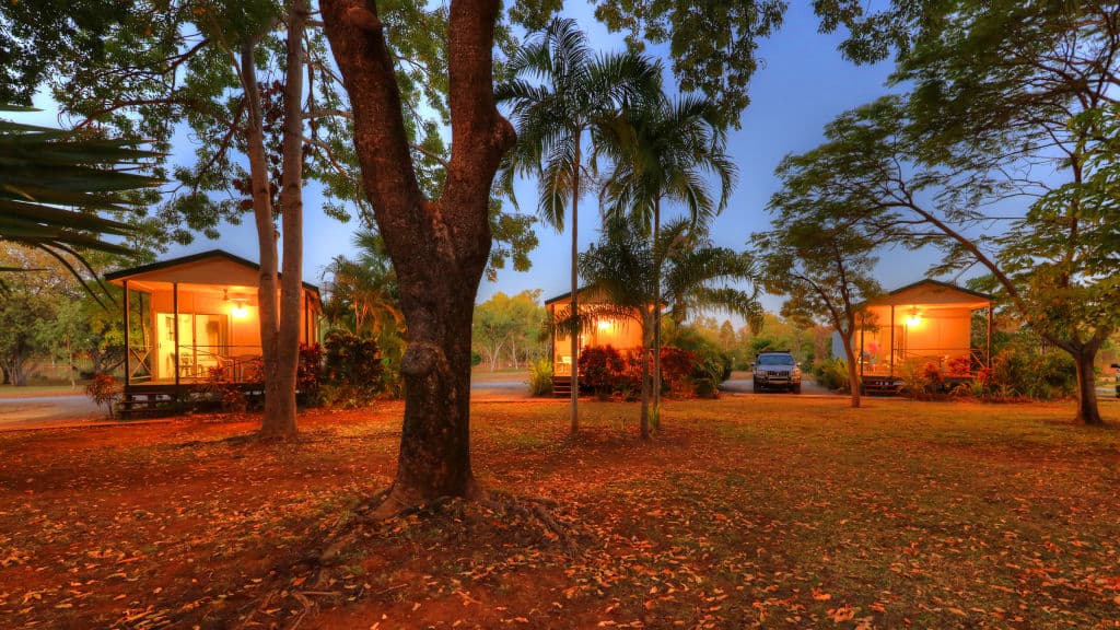 Trees surround the Katherine property and small cabins.