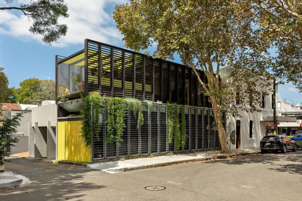The exterior of a modern rear office along a primarily residential street.