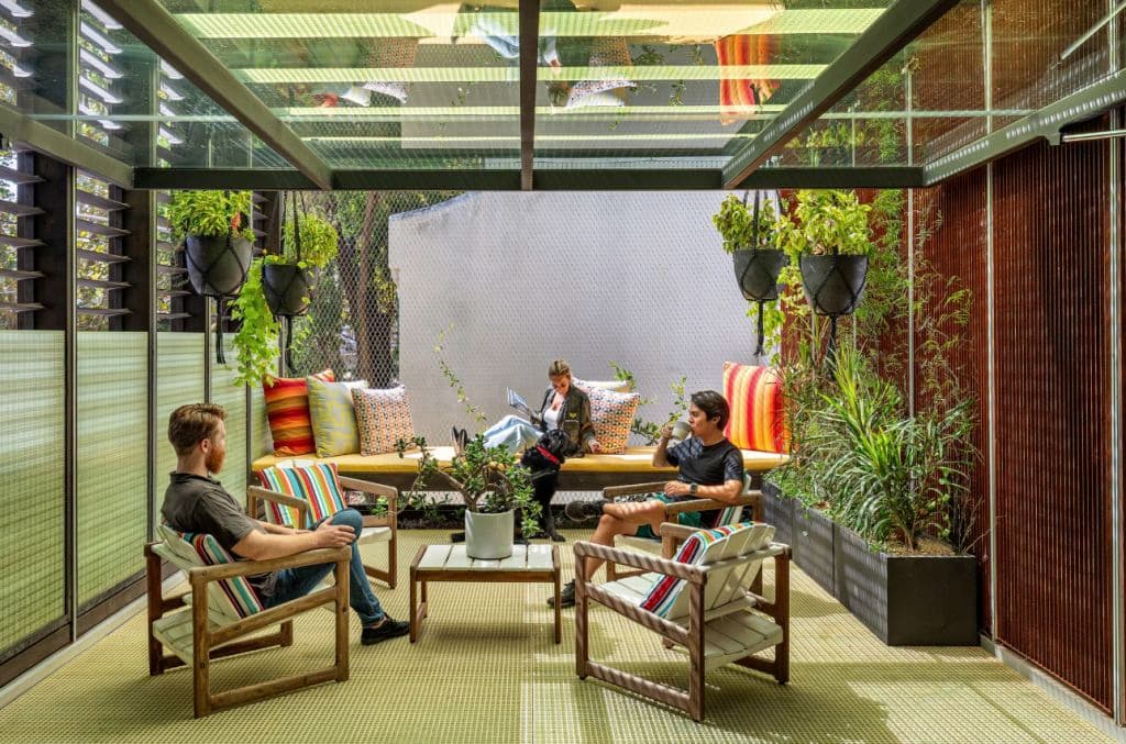 People sitting around outside in lounge furniture.
