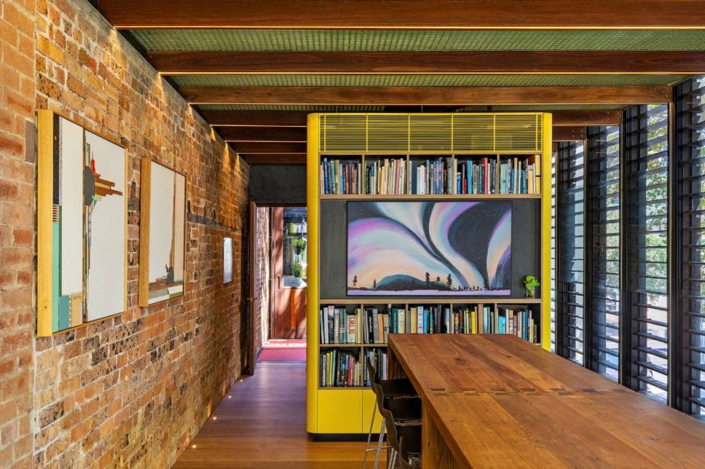 A long table and exposed bricks on a wall.